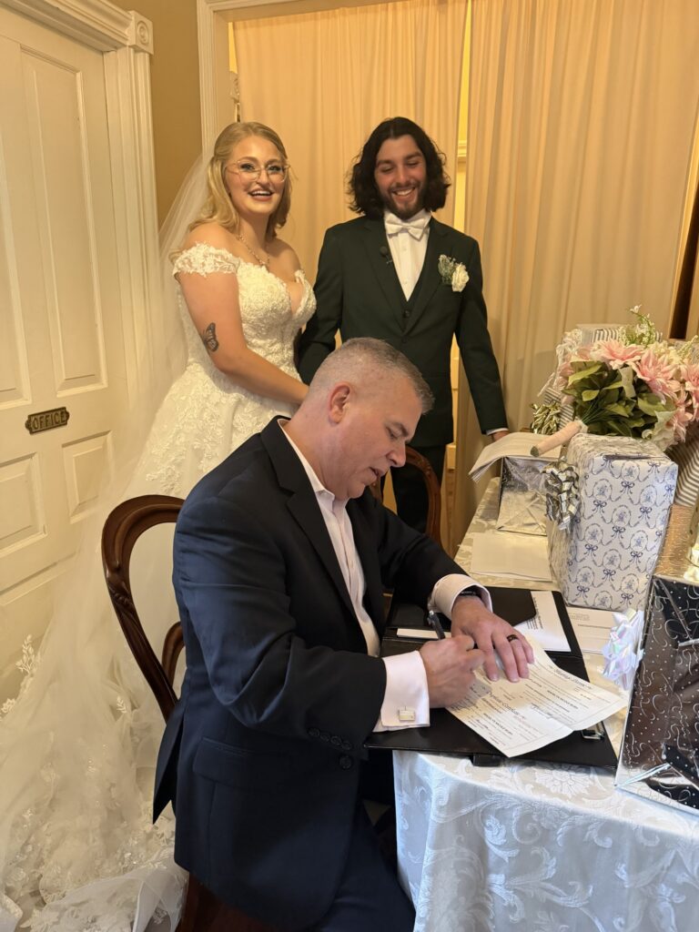Ever After Vows completing a marriage license signing with newlyweds