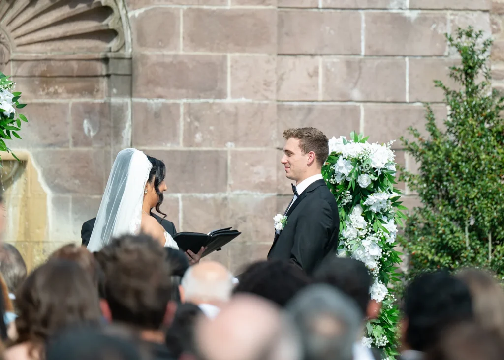 Ben and Aryana facing each other during their wedding ceremony at Tyler Gardens in Newtown, Pennsylvania, with Ever After Vows officiating