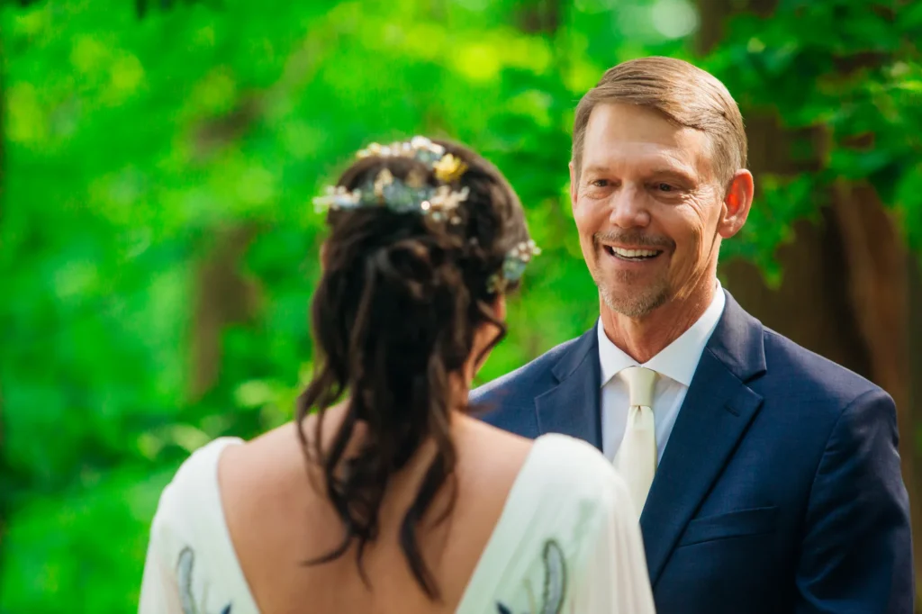 Doug smiles at Ellie during their outdoor wedding ceremony at Vixen Hill Farm.