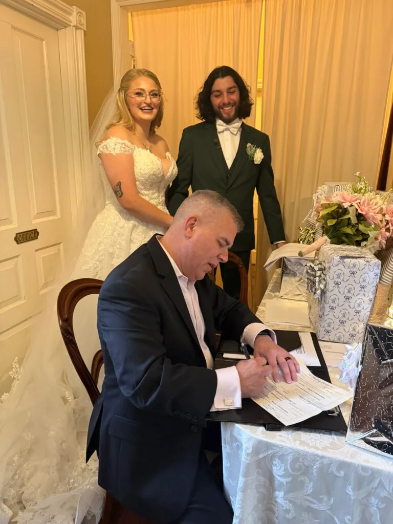 Ever After Vows completing a marriage license signing with newlyweds