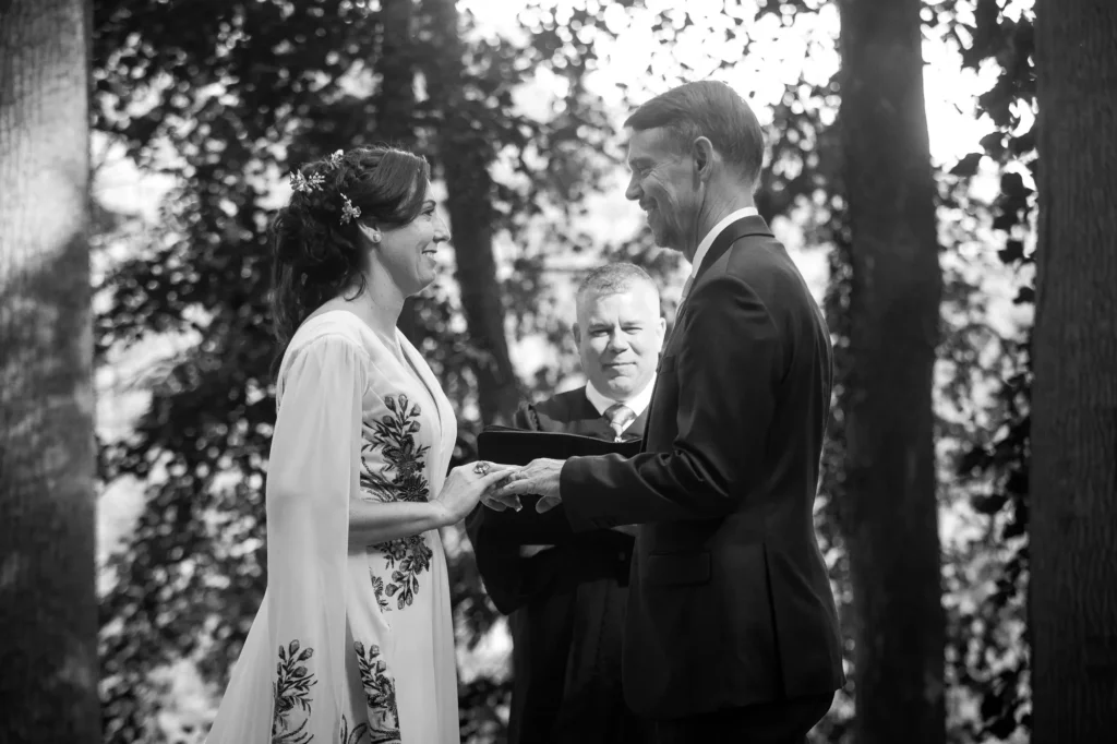 Ellie and Doug exchanging vows with their officiant during their Vixen Hill Farm ceremony