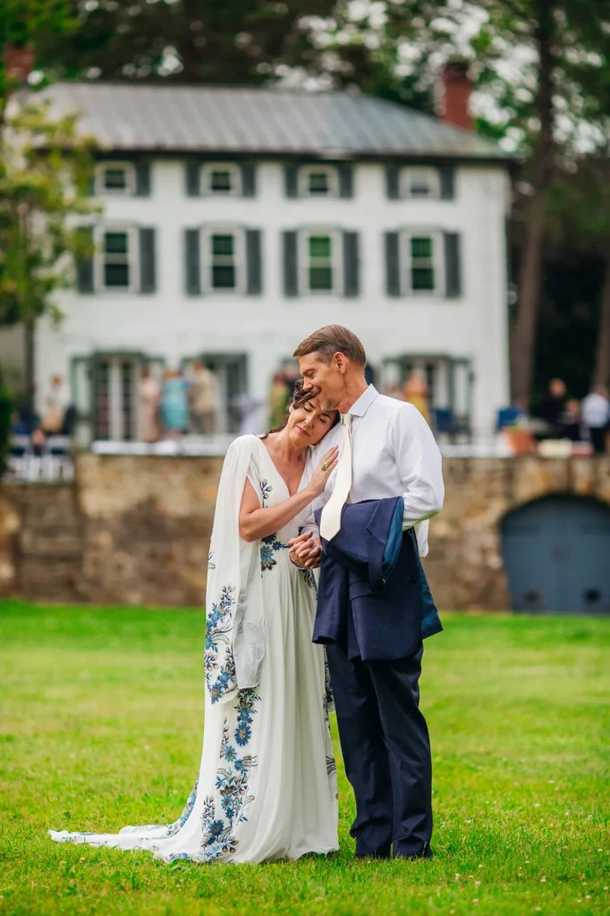 Ellie and Doug share a kiss outside the farmhouse following their wedding.