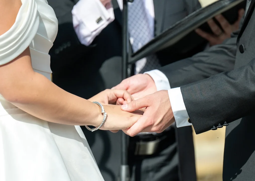 Close-up of Ben and Aryana exchanging wedding rings during their ceremony at Tyler Gardens in Newtown, Pennsylvania